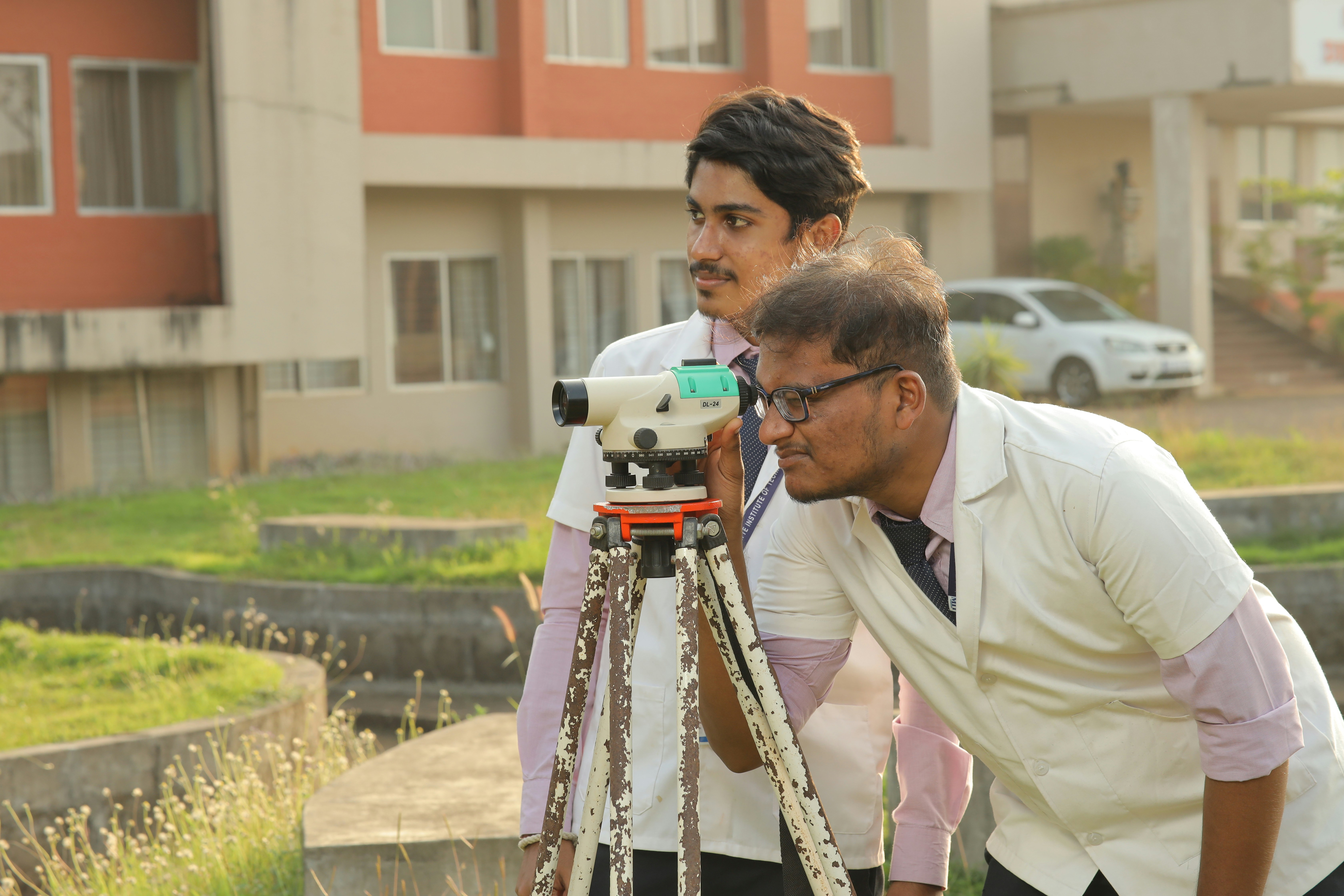 Surveyor operating a total station in the field